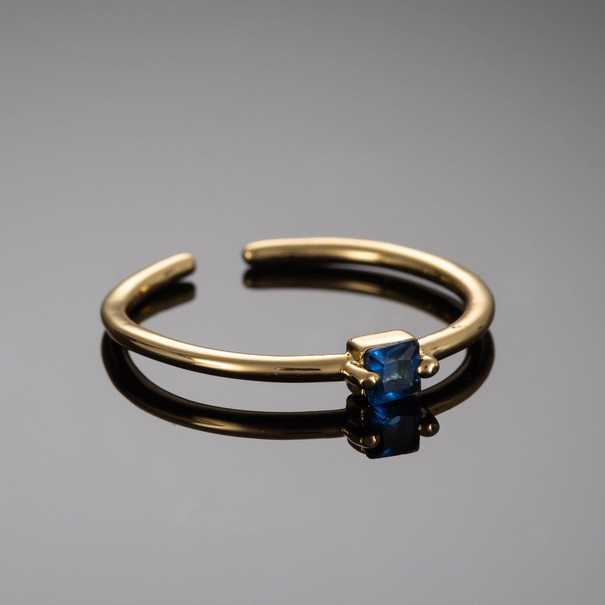 Adjustable Gold Plated Ring for Women with a Blue Cubic Zirconia Stone - namana.london